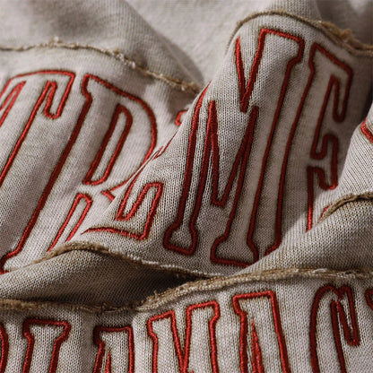 A premium cotton pullover hoodie with an embroidered letter patch in a variety of classic autumn colours