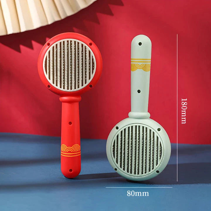 One-Click Pet Hair Removal Comb in red colour, designed to effectively remove loose fur and tangles from cat or dog coats