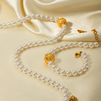 An elegant 18K gold-plated stainless steel bracelet featuring a flower ball design with a lustrous pearl centre