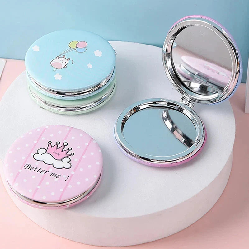 Compact portable foldable makeup mirror with cute cartoon prints for on-the-go beauty touch-ups