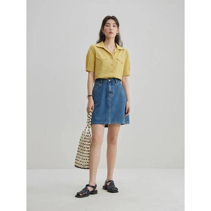 Chic high-waisted denim skirt in a classic blue shade, featuring an A-line silhouette and a flattering empire waistline.