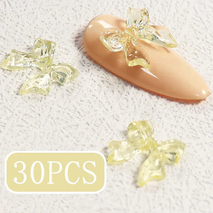 Charming candy-coloured bow nail charms in various colours, perfect for adding a playful touch to your manicure