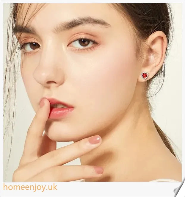 Elegant sterling silver earrings featuring a heart-shaped design and sparkling cubic zirconia stones