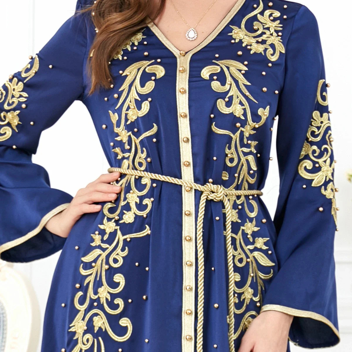 A sophisticated long-sleeve women's dress with a captivating floral embroidery pattern and a refined colour palette, suitable for a variety of occasions.