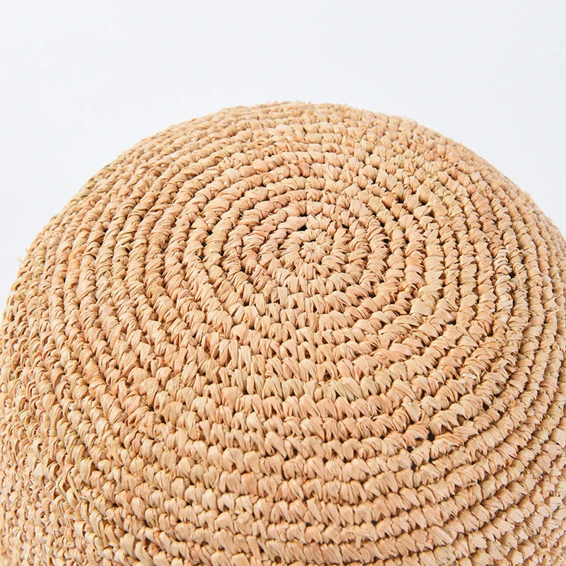 Handcrafted raffia sun hat for women, with a flat brim design and adjustable sizing for versatile sun protection and stylish summer wear
