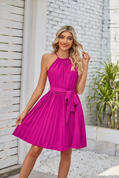 Elegant halter sundress in a variety of colours, featuring a pleated skirt and adjustable waistline for a customised fit
