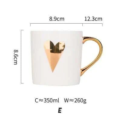 Elegant porcelain coffee mug with a lustrous gold heart design, perfect for enjoying hot beverages in style.