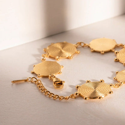 Close-up of a luxurious 18K gold plated stainless steel bracelet with an elegant palace-style design