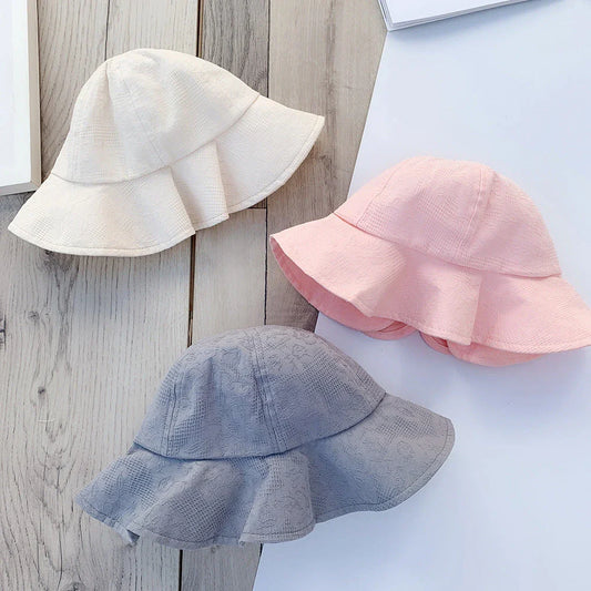 Adorable pink princess baby bucket hat with bow detail for sun protection and fashionable wear