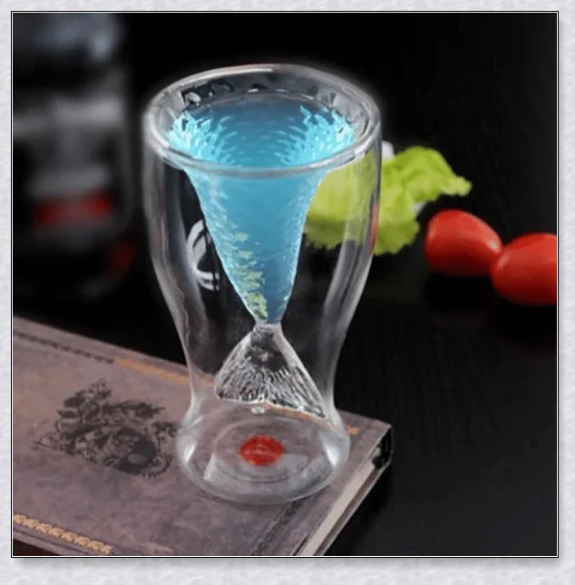 A transparent glass mug with a decorative mermaid tail design, perfect for enjoying a range of beverages in style.