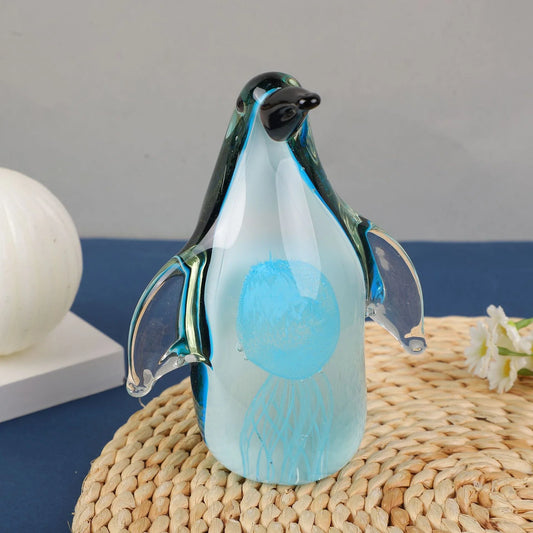 Exquisite handcrafted glass penguin ornament with a striking green-backed design, showcasing the beauty of marine life