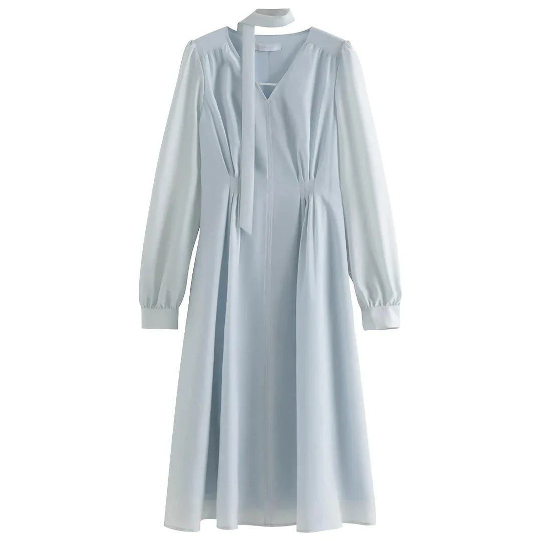 A light blue dress with a v-neck, puff sleeves, and a ribbon detail at the waist