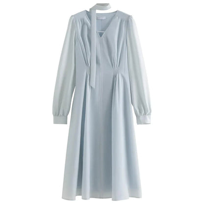 A light blue dress with a v-neck, puff sleeves, and a ribbon detail at the waist