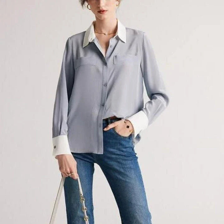 A chic and elegant silk crepe de chine blouse in a timeless solid pattern, perfect for professional and casual wear.