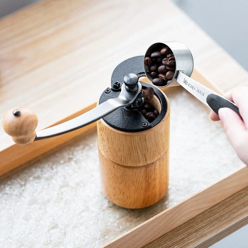 Elegant wooden manual coffee grinder with steel conical burr for consistent, flawless grinding