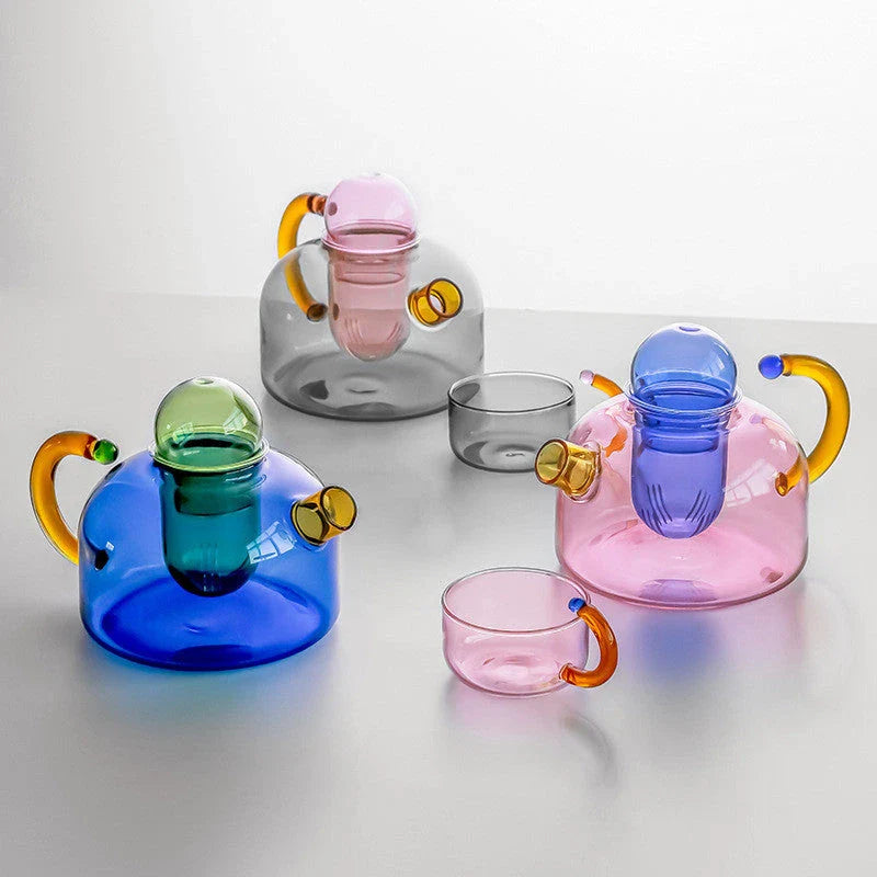 Elegant glass teapot and teacup set in vibrant contrasting colours, designed for a refined tea experience