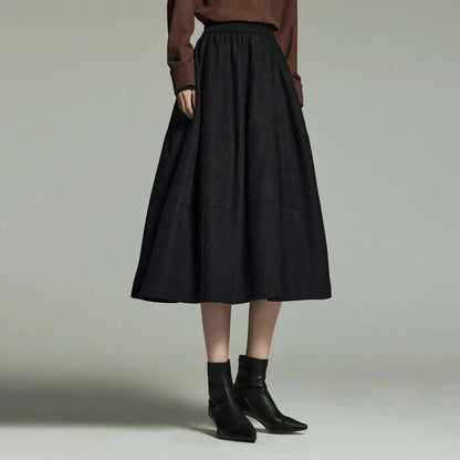 A stylish and sophisticated mid-length A-line pleated skirt with pockets, crafted from high-quality twill fabric for durability and comfort.