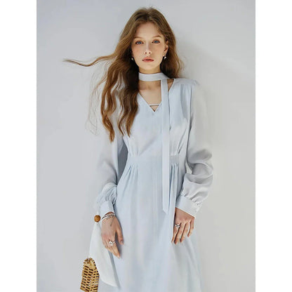 Elegant French-style v-neck light blue ribbon dress with puff sleeves and A-line silhouette