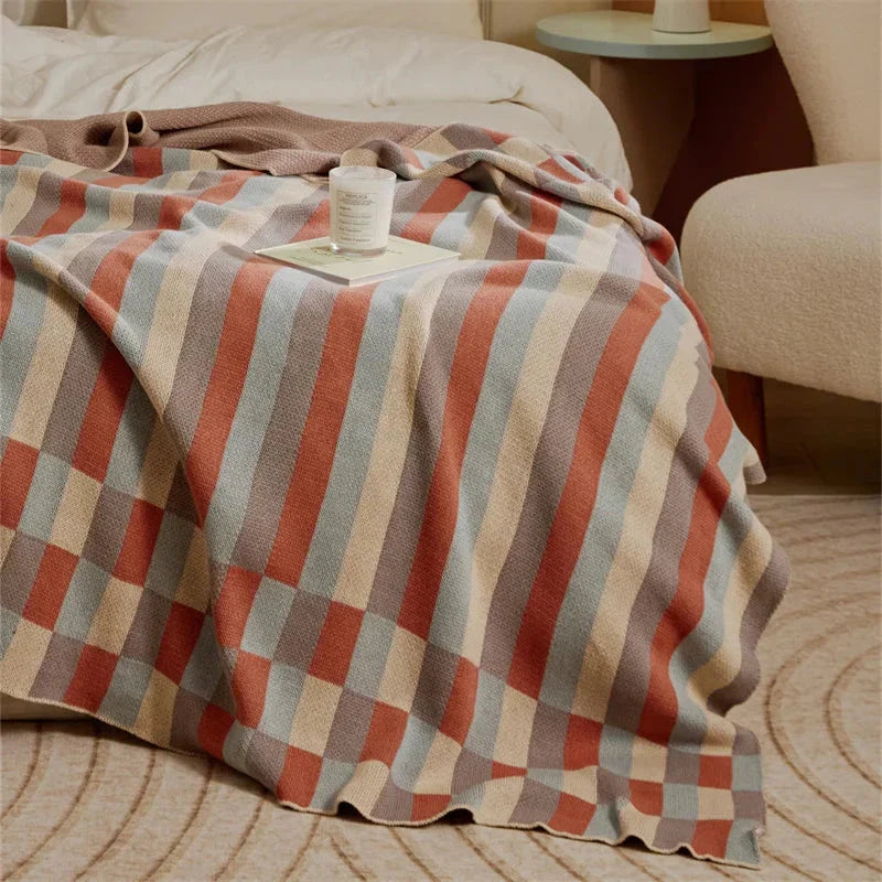 Cosy 100% cotton striped plaid throw blanket in vibrant orange and blue hues, perfect for adding rustic charm to any living space.