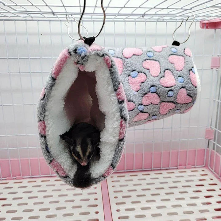 Cosy plush tunnel in grey for small pets like hamsters and guinea pigs, providing a comfortable and secure hideaway