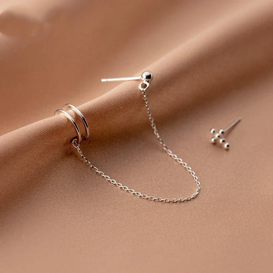 Asymmetric sterling silver one-piece earring and ear clip set with a modern and distinctive design