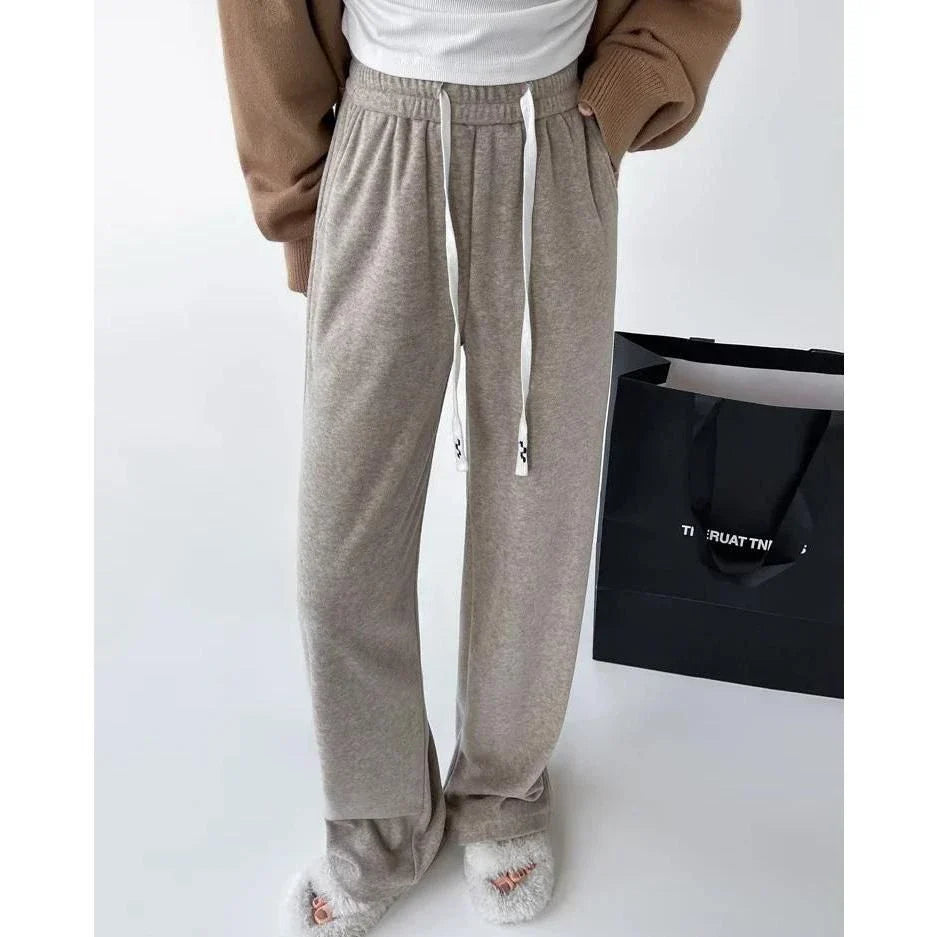 Elegant high-waist drawstring trousers in black, featuring a wide-leg cut and stylish lace-up pockets