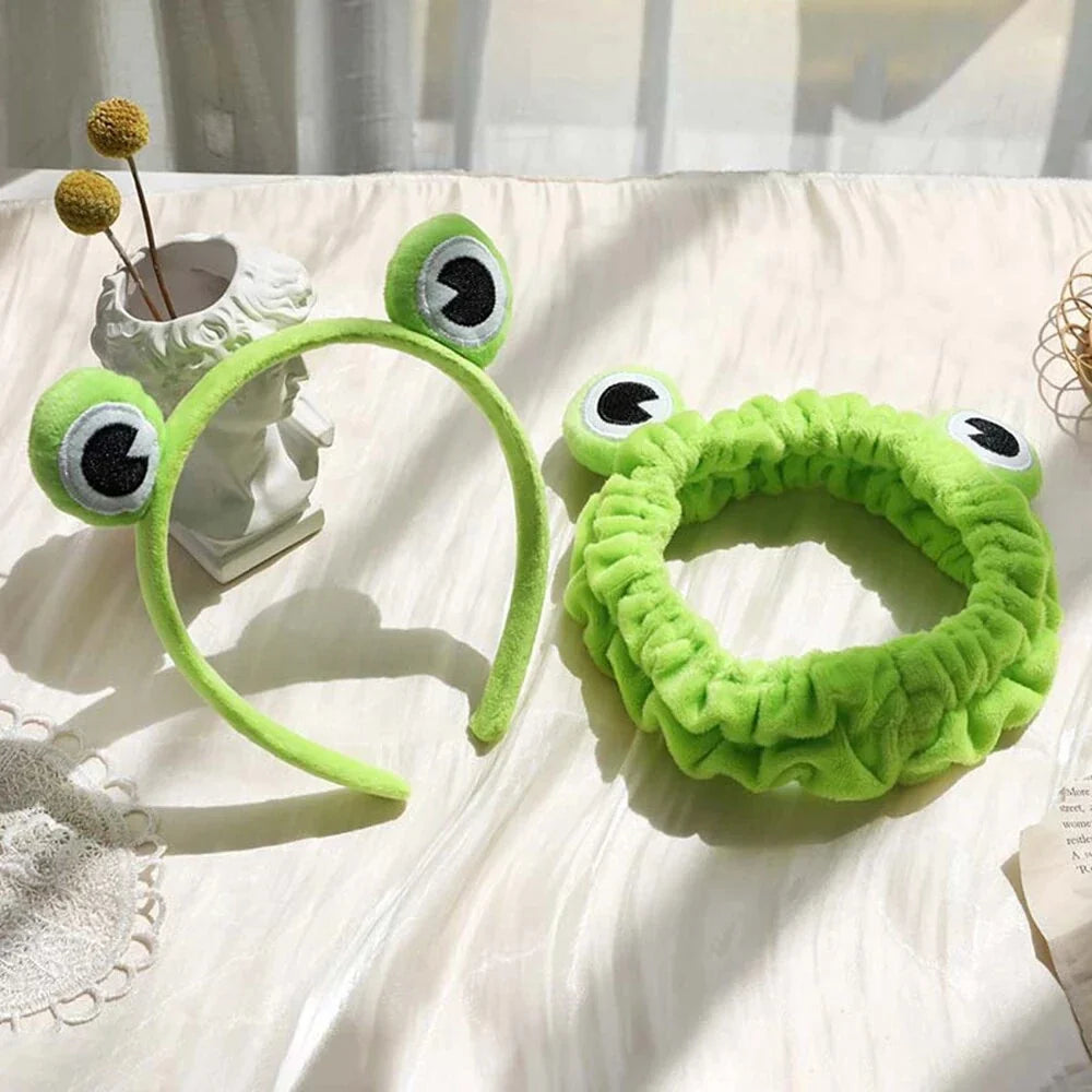 Charming frog-themed headband with plush coral fleece material and elastic band for a comfortable, customized fit