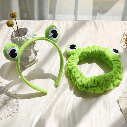 Charming frog-themed headband with plush coral fleece material and elastic band for a comfortable, customized fit