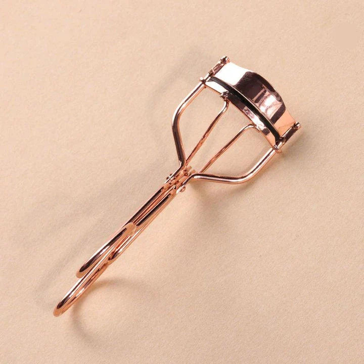 Rose gold eyelash curler with a silicone pad for gentle, long-lasting lash curling