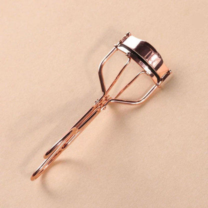 Rose gold eyelash curler with a silicone pad for gentle, long-lasting lash curling