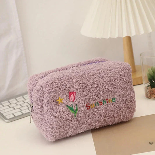 Elegant embroidered flowers cosmetic pouch made of soft, plush material in ivory colour