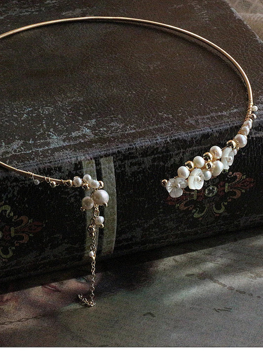 Elegant handcrafted clavicle necklace made of natural pearl shell with an intricate floral pattern, a timeless British design accessory.