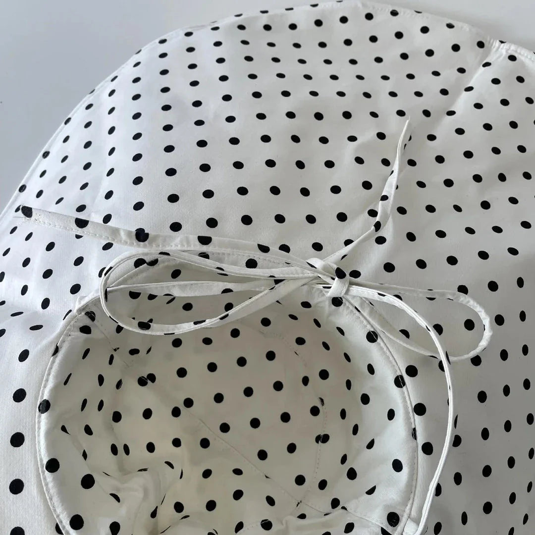 Elegant oversized polka dot sun hat for stylish UK women, offering excellent sun protection and a classic, fashionable design.