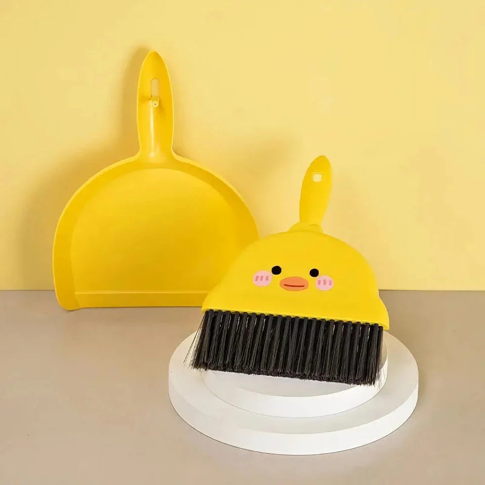 Compact table broom and dustpan set for children, featuring a yellow broom and dustpan made of durable materials for easy cleaning and tidying of small spaces.