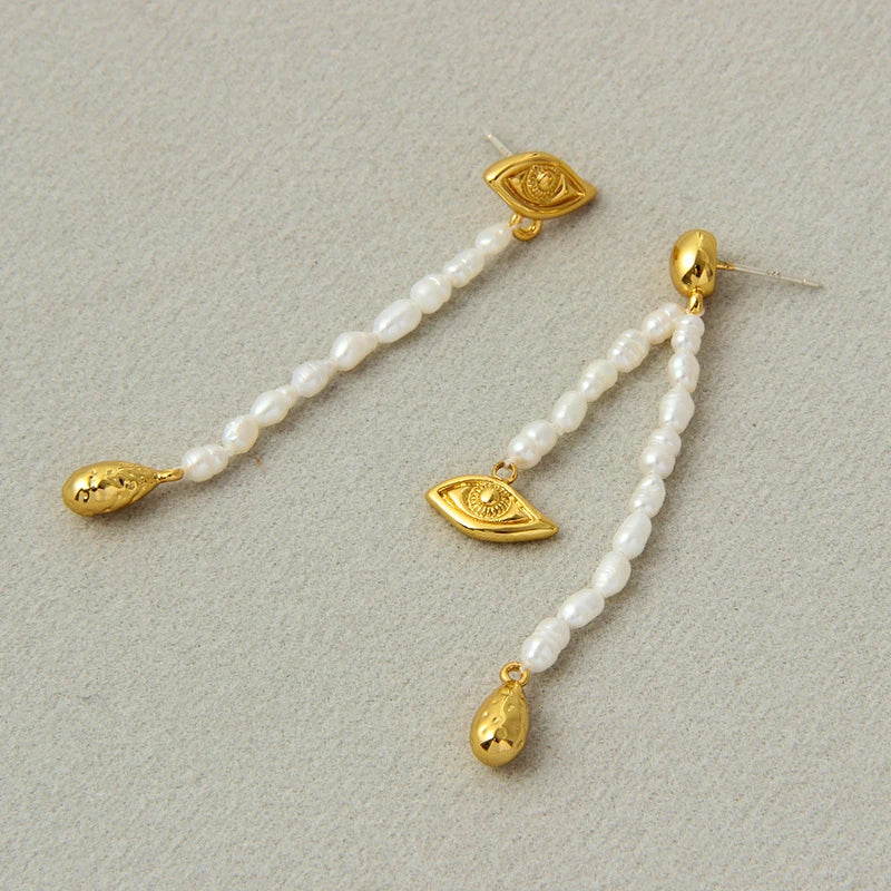 Pair of elegant, asymmetrical pearl earrings with a luxurious and sophisticated design