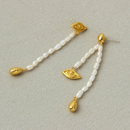 Pair of elegant, asymmetrical pearl earrings with a luxurious and sophisticated design